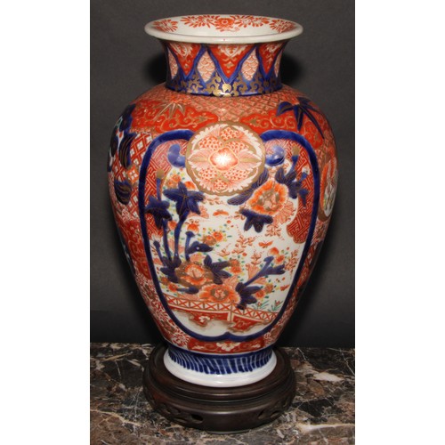 456 - A Japanese ovoid vase, decorated in the Imari palette with birds, landscapes and floral motifs, pick... 