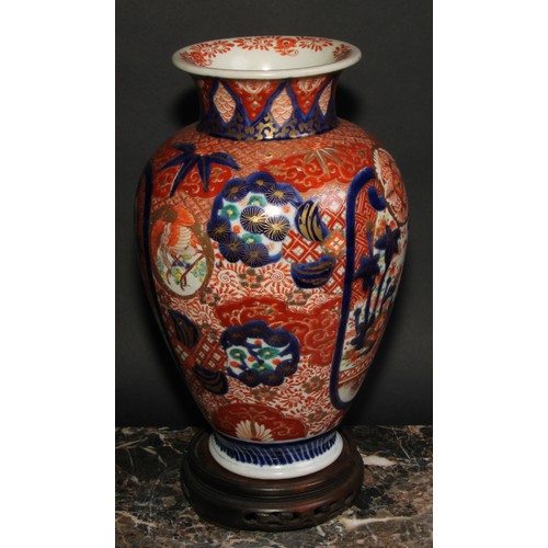 456 - A Japanese ovoid vase, decorated in the Imari palette with birds, landscapes and floral motifs, pick... 