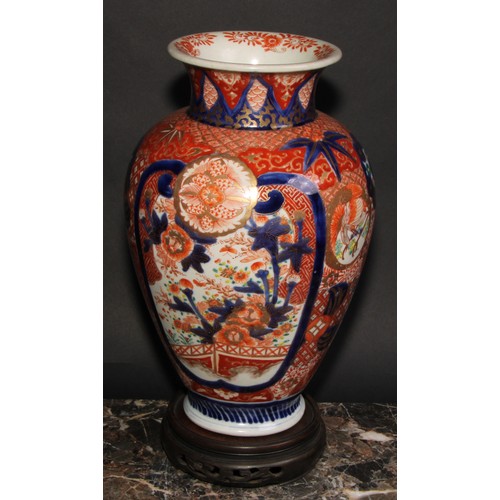 456 - A Japanese ovoid vase, decorated in the Imari palette with birds, landscapes and floral motifs, pick... 