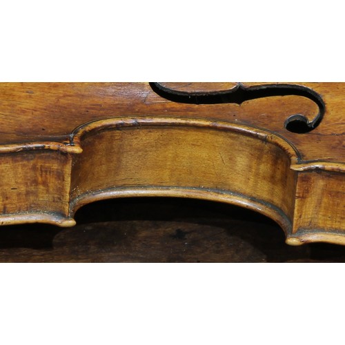 2564 - A violin, the two-piece back 35.75cm long excluding button, rosewood tuning pegs, outlined throughou... 