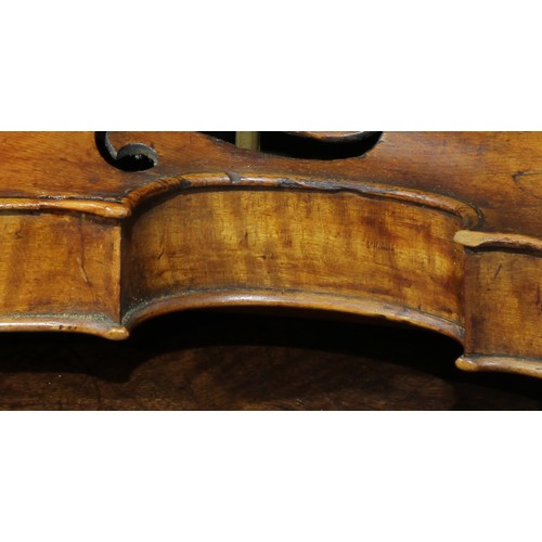 2564 - A violin, the two-piece back 35.75cm long excluding button, rosewood tuning pegs, outlined throughou... 