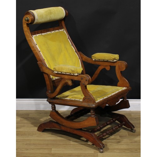 1566 - An unusual 19th century American walnut rocking chair, adjustable headrest, shaped arms, reeded bord... 