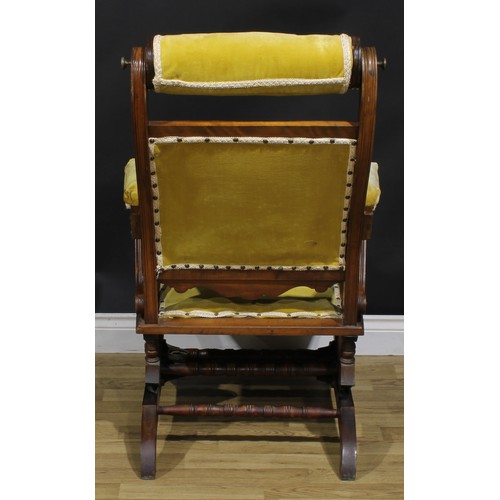 1566 - An unusual 19th century American walnut rocking chair, adjustable headrest, shaped arms, reeded bord... 