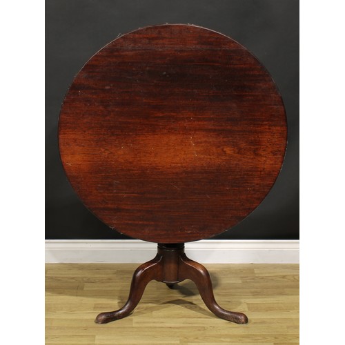 1534 - A George III mahogany tripod supper table, circular top, turned baluster pillar, cabriole legs, pad ... 