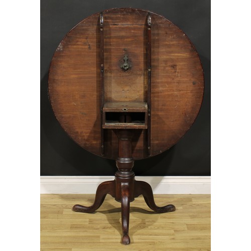 1534 - A George III mahogany tripod supper table, circular top, turned baluster pillar, cabriole legs, pad ... 