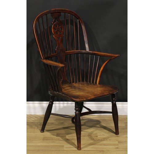 1532 - A 19th century yew and elm wheelback Windsor elbow chair, saddle seat, crinoline stretcher, 98cm hig... 