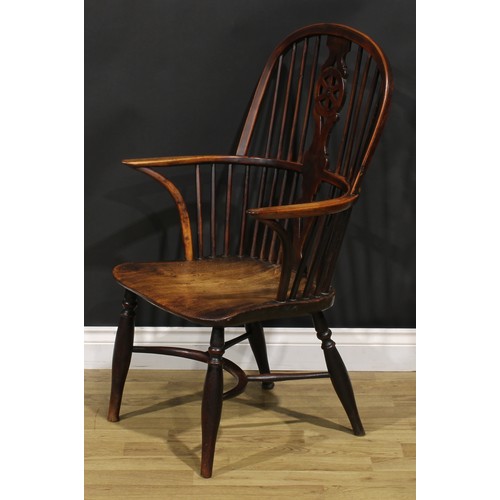 1532 - A 19th century yew and elm wheelback Windsor elbow chair, saddle seat, crinoline stretcher, 98cm hig... 