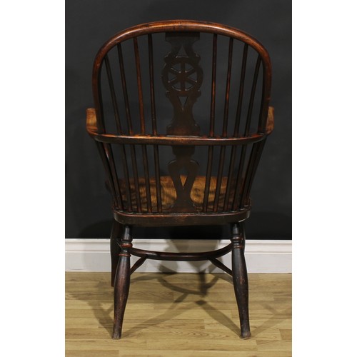 1532 - A 19th century yew and elm wheelback Windsor elbow chair, saddle seat, crinoline stretcher, 98cm hig... 