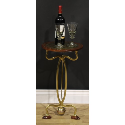 1550 - An Art Nouveau brass and hardwood wine or lamp table, circular top inlaid with a reserve chased with... 