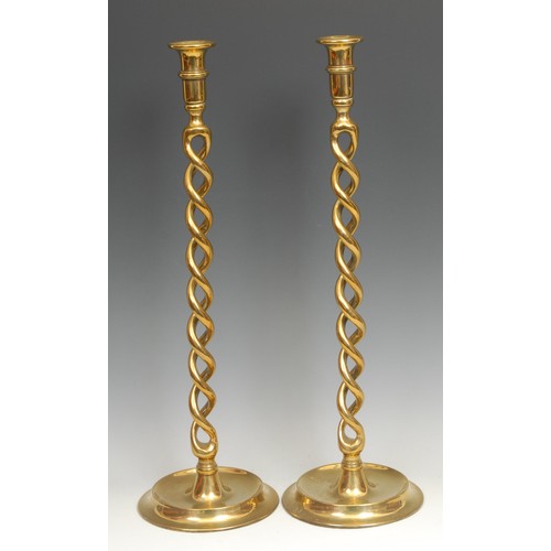 2178 - A pair of tall late Victorian/Edwardian brass open barley twist candlesticks, dished circular bases,... 