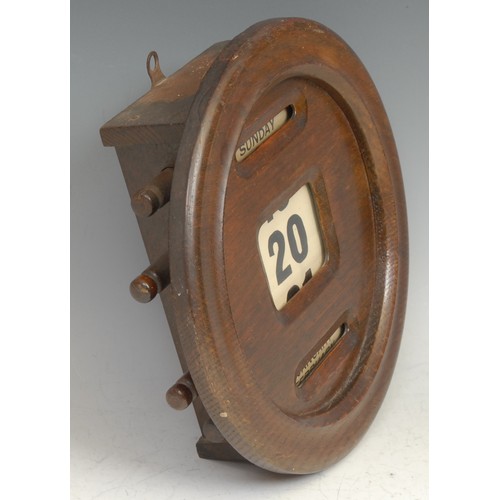 1499 - An early 20th century oak circular wall mounted perpetual calendar, glazed apertures for day, date a... 