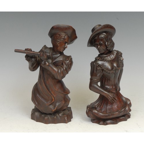 2140 - A pair of Continental mahogany carvings, of a flautist and a dancer, 20cm high, 19th century