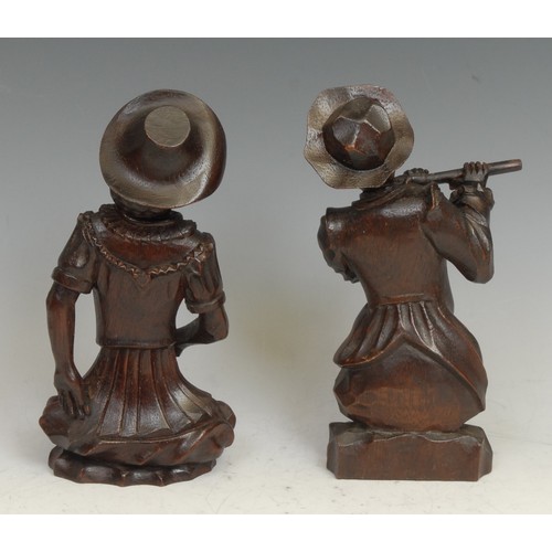 2140 - A pair of Continental mahogany carvings, of a flautist and a dancer, 20cm high, 19th century