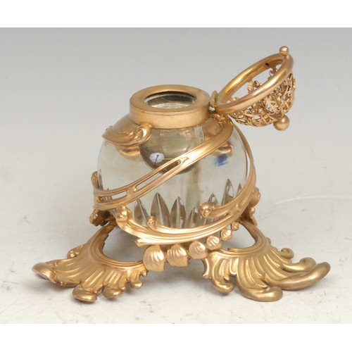 1408 - A 19th century French gilt metal and clear glass inkwell, pierced and embossed in the Rococo taste, ... 