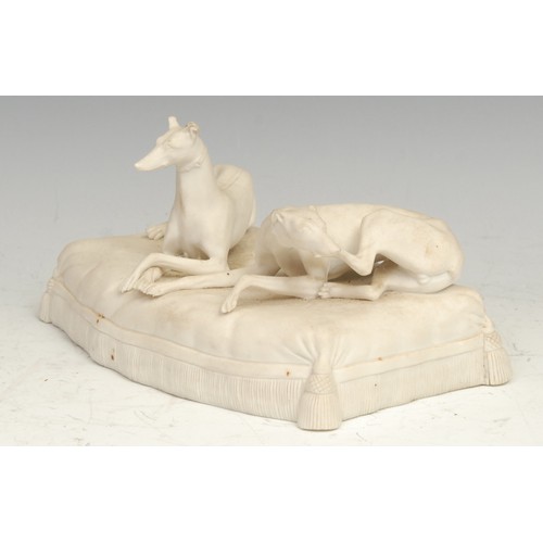 1734 - A 19th century parian ware sculpture, modelled with two greyhounds on a tasselled cushion, 18.56cm w... 