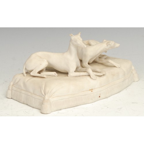 1734 - A 19th century parian ware sculpture, modelled with two greyhounds on a tasselled cushion, 18.56cm w... 