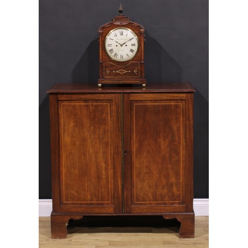 1245 - A 19th century mahogany enclosed bookcase, oversailing top above a pair of panel doors enclosing adj... 