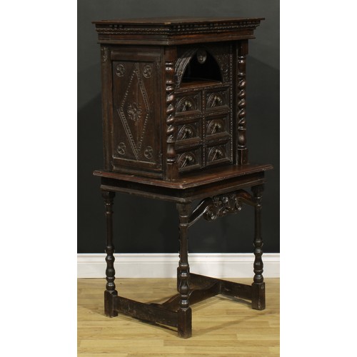 1293 - A 19th century Continental oak collector’s cabinet on stand, dentil cornice above an arched niche an... 