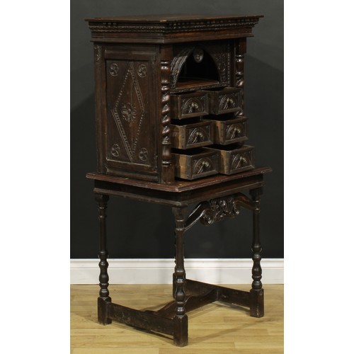 1293 - A 19th century Continental oak collector’s cabinet on stand, dentil cornice above an arched niche an... 