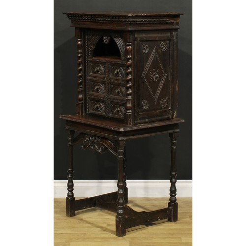 1293 - A 19th century Continental oak collector’s cabinet on stand, dentil cornice above an arched niche an... 