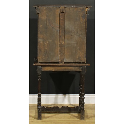 1293 - A 19th century Continental oak collector’s cabinet on stand, dentil cornice above an arched niche an... 