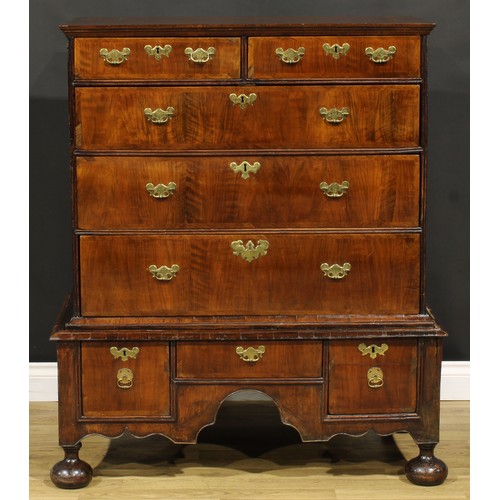 2123 - A Queen Anne/George I walnut chest on stand, moulded top above two short and three long graduated dr... 