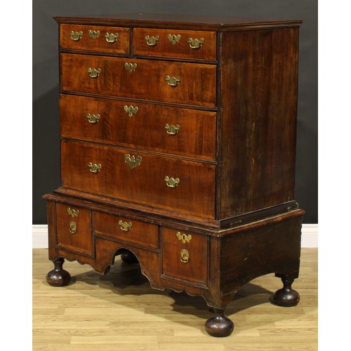 2123 - A Queen Anne/George I walnut chest on stand, moulded top above two short and three long graduated dr... 