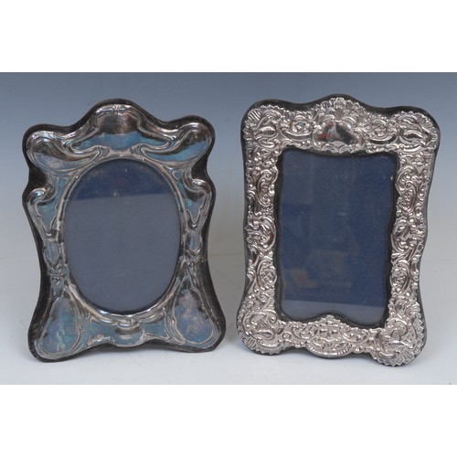 752 - An Art Nouveau style silver easel photograph frame, 20cm high, London 1979; another, Victorian style... 