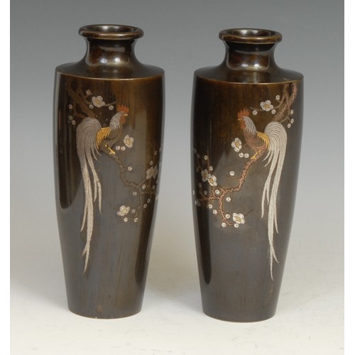 374 - A pair of Japanese bronze and ovoid vases, each inlaid in silver and mixed metals with cockerels per... 