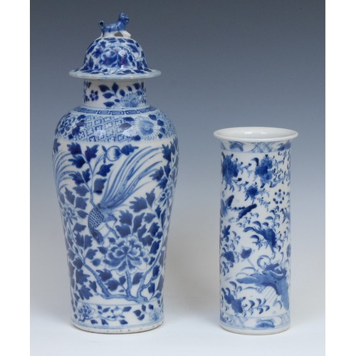 384 - A Chinese baluster vase and cover, painted in tones of underglaze blue with exotic birds amongst bra... 