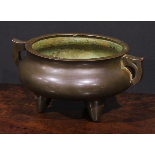 435 - A Chinese bronze tripod ding censer, scroll handles, 22cm wide, 19th century