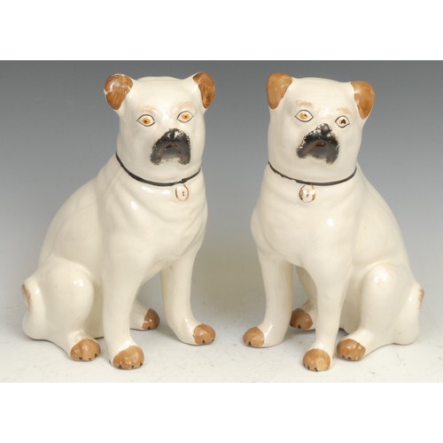 100 - A pair of 19th century Staffordshire pottery models, of pug dogs, seated to left and right, 24cm hig... 