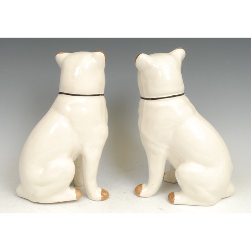 100 - A pair of 19th century Staffordshire pottery models, of pug dogs, seated to left and right, 24cm hig... 