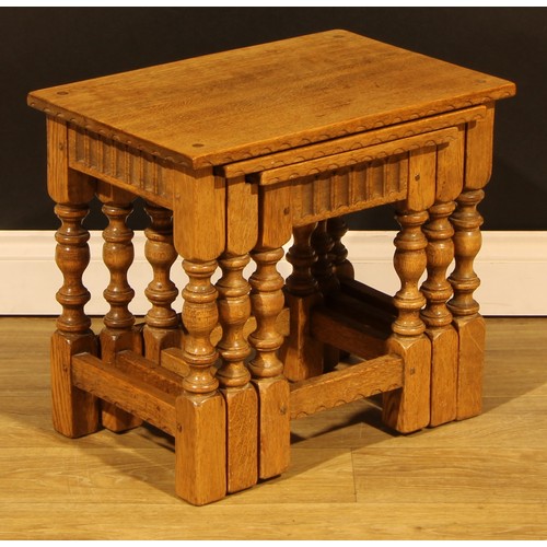 1564 - An oak nest of three occasional tables, by Rupert/Nigel Griffiths Monastic Woodcraft, the largest 45... 