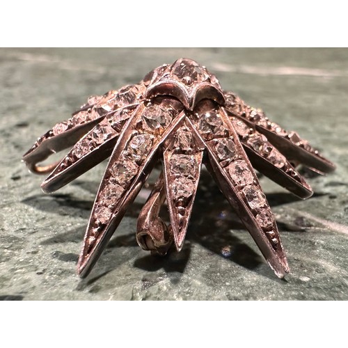 932 - An Art Deco diamond and white coloured metal starburst brooch, the central round rose-cut stone set ... 