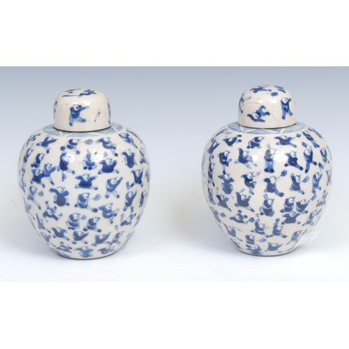 353 - A pair of Chinese blue and white ovoid ginger jars and covers, painted in tones of underglaze blue w... 