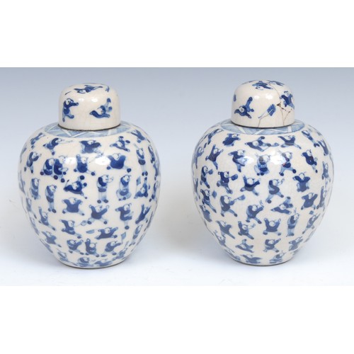 353 - A pair of Chinese blue and white ovoid ginger jars and covers, painted in tones of underglaze blue w... 