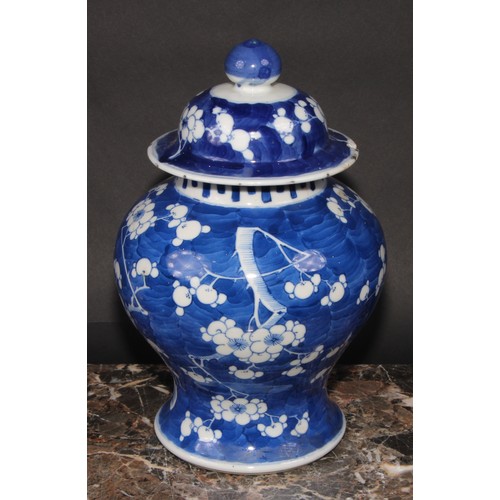 383 - A Chinese baluster ginger jar and cover, painted in tones of underglaze blue with blossoming prunus ... 