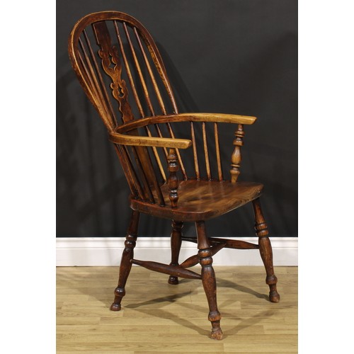 1656 - A 19th century Yorkshire beech, ash and elm Windsor elbow chair, hoop back, shaped and pierced Chris... 