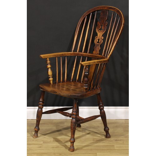 1656 - A 19th century Yorkshire beech, ash and elm Windsor elbow chair, hoop back, shaped and pierced Chris... 