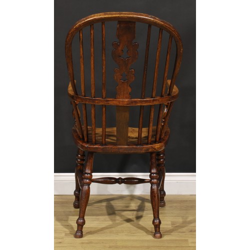 1656 - A 19th century Yorkshire beech, ash and elm Windsor elbow chair, hoop back, shaped and pierced Chris... 