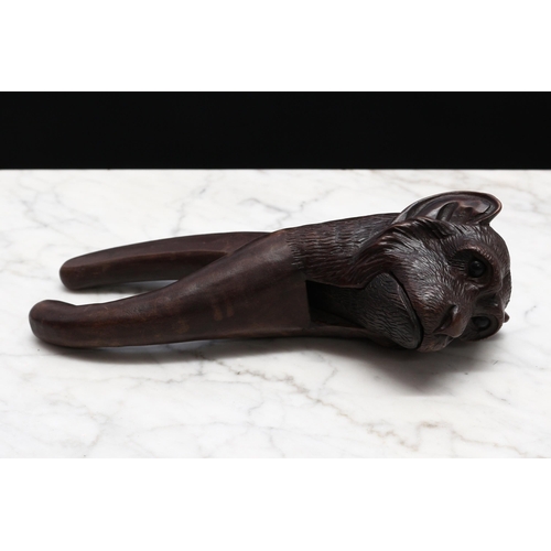 2275 - Nutcrackers - a Black Forest novelty lever-action nut cracker, carved as the head of a monkey, 19cm ... 