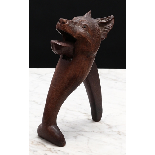 2271 - Nutcrackers - a Black Forest novelty lever-action nut cracker, carved as the head of a dog, glass ey... 