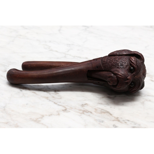 2272 - Nutcrackers - a Black Forest novelty lever-action nut cracker, carved as the head of a dog, wearing ... 