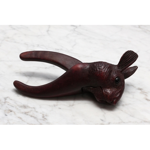 2276 - Nutcrackers - a Black Forest novelty lever-action nut cracker, carved as the head of a rabbit, glass... 