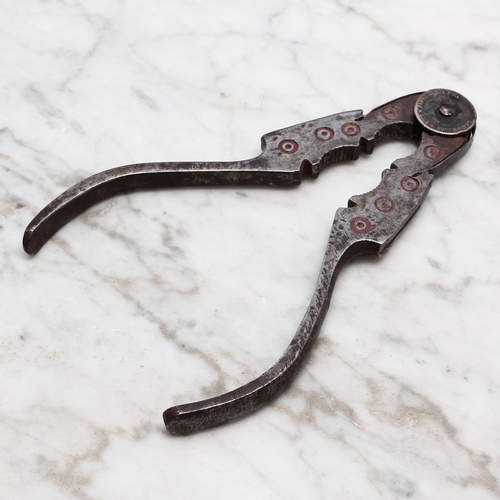 2253 - Nutcrackers - a 19th century Spanish iron sprung lever-action nut cracker, shaped jaws, decorated wi... 