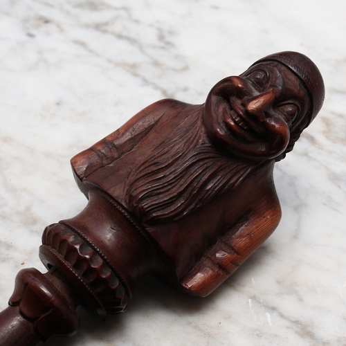 2278 - Nutcrackers - a Black Forest novelty screw-action nut cracker, carved as a bearded man, half-length,... 