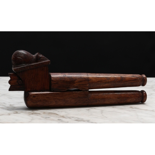 2328 - Nutcrackers - an oak lever-action nut cracker, carved with a mouse in the manner of Robert Thompson,... 