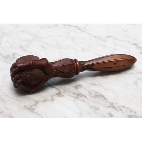 2282 - Nutcrackers - a Black Forest novelty screw-action nut cracker, carved as a fist grasping a walnut, l... 