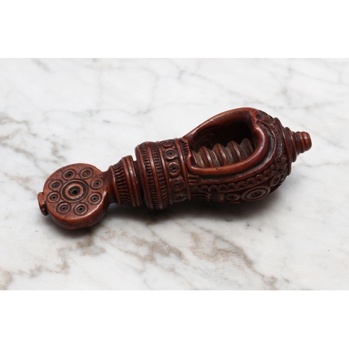 2254 - Nutcrackers - a 19th century Swiss acorn shaped screw-action nut cracker, carved with a band of lotu... 